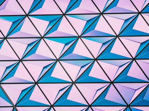 Symmetric cyan geometric shapes on dark background representing balance